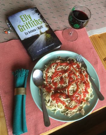 Speghetti med kalkonfärs, ett glas rött och Elly Griffiths bok En kvinna i blått
