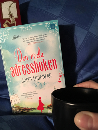 Den röda adressboken och kaffe på sängen