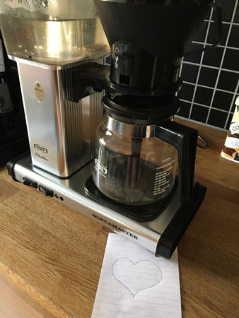 Laddad kaffebryggare och hjärta på en lapp