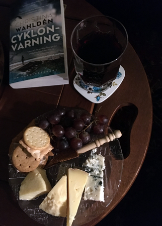 Ostassiett vin och boken Cyklonvarning