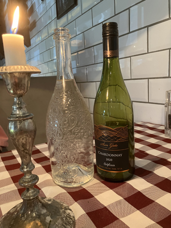 Sun Gate Chardonnay 2020 vattenflaska och tänt ljus Trattoria Alessandro