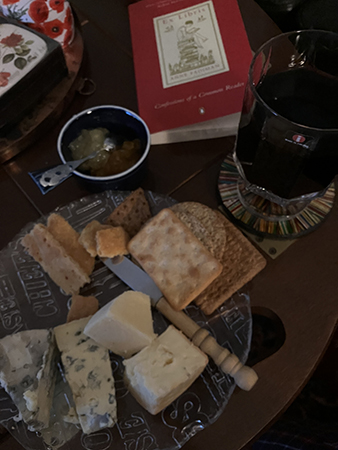 Ostassiett ett glas rött och boken Ex Libris