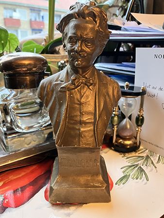 Strindbergfigur på skrivbordet