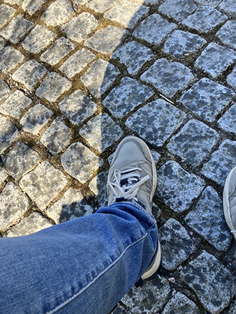 Mina ben och skor på kullerstenar