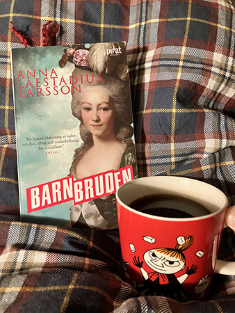 Barnbruden och kaffe ur lilla Mymugg på sängen