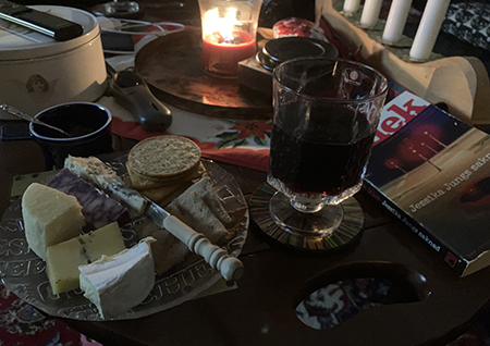 Ostassiett ett glas rött tänt ljus i Salen