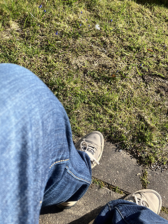 Väntar på en bänk i aprilsolen