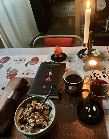 Onsdagsfrukost i september med tända ljus och boken Återgäldaren Onsdagsfrukost i september med tända ljus och boken Återgäldaren