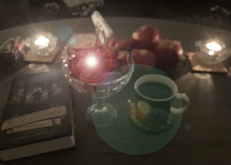 Boken Drottningen godisskål och kaffe på vardagsrumsbordet m tända ljus