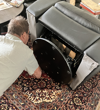 Gästarbetare grejar med reclinerfåtöljen