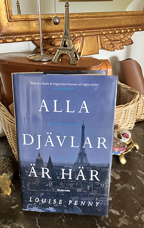 Boken Alla djävlar är här med Eiffeltornet ovanpå Boken Alla djävlar är här med Eiffeltornet ovanpå