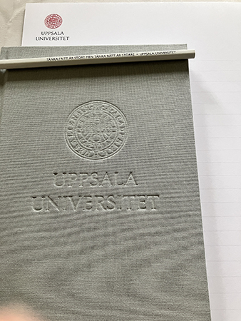 Uppsala universitet grå skrivbok och block