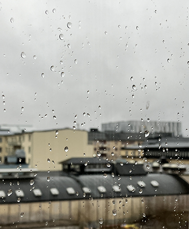 Regndroppar på vardagsrumsfönstret Regndroppar på vardagsrumsfönstret